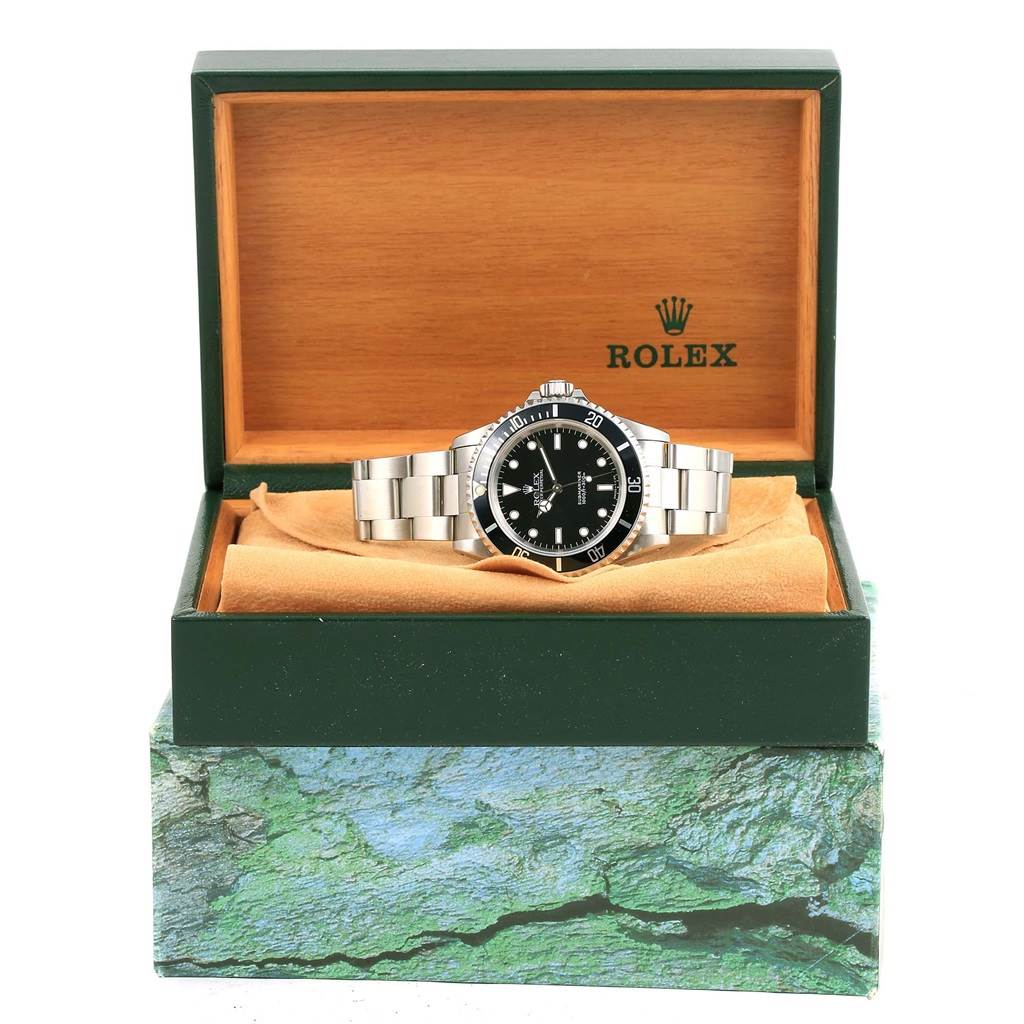 The Rolex Submariner 14060 Men's Stainless Steel Black Dial 14060 Men's Stainless Steel Black Dial watch is shown from the front, displayed in an open green and wooden Rolex box.