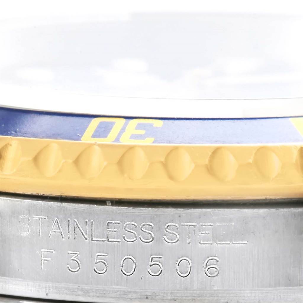 The image shows the side view of a Rolex Submariner 16613 Men's Steel and Gold (two tone) Blue Dial 16613 Men's Steel and Gold (two tone) Blue Dial with a stainless steel case and part of its two-tone bezel.