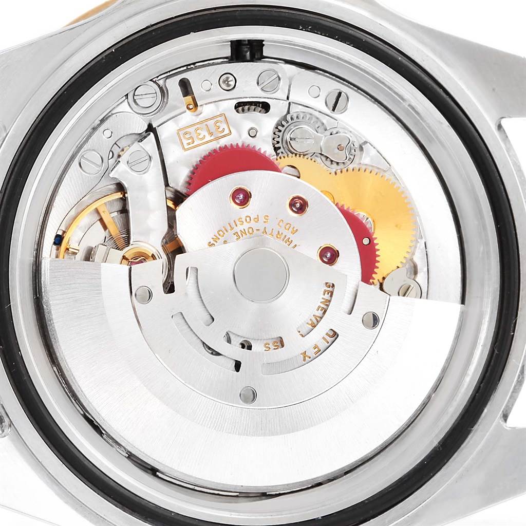 This image shows the internal mechanism of a Rolex Submariner 16613 Men's Steel and Gold (two tone) Blue Dial 16613 Men's Steel and Gold (two tone) Blue Dial watch from a back view, highlighting gears and components.