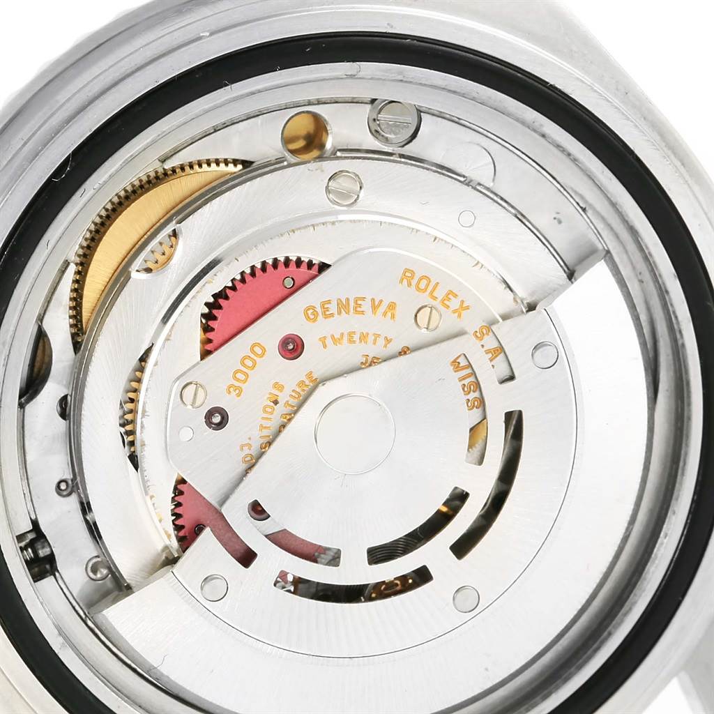 The image shows an internal view of the Rolex Submariner 14060 Men's Stainless Steel Black Dial 14060 Men's Stainless Steel Black Dial model, highlighting its intricate movement mechanism.