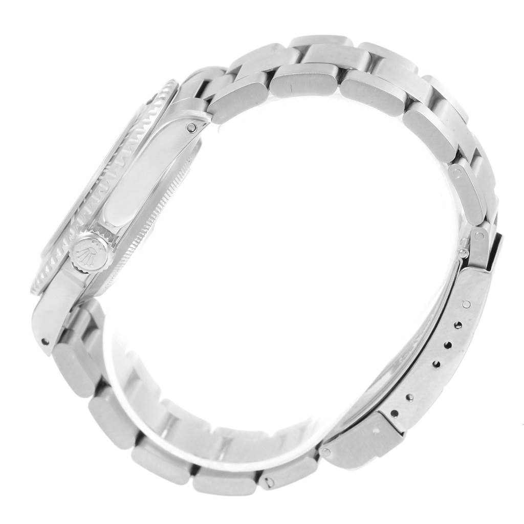 This image shows a side view of a Rolex Submariner 14060 Men's Stainless Steel Black Dial 14060 Men's Stainless Steel Black Dial watch, featuring its crown and metal bracelet.