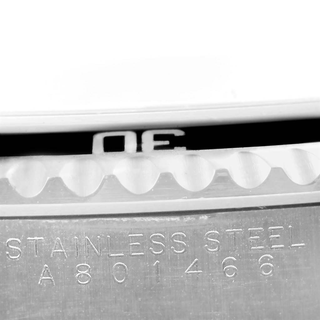 The image shows a close-up of the bezel and the stainless steel casing of a Rolex Submariner 14060 Men's Stainless Steel Black Dial 14060 Men's Stainless Steel Black Dial watch.