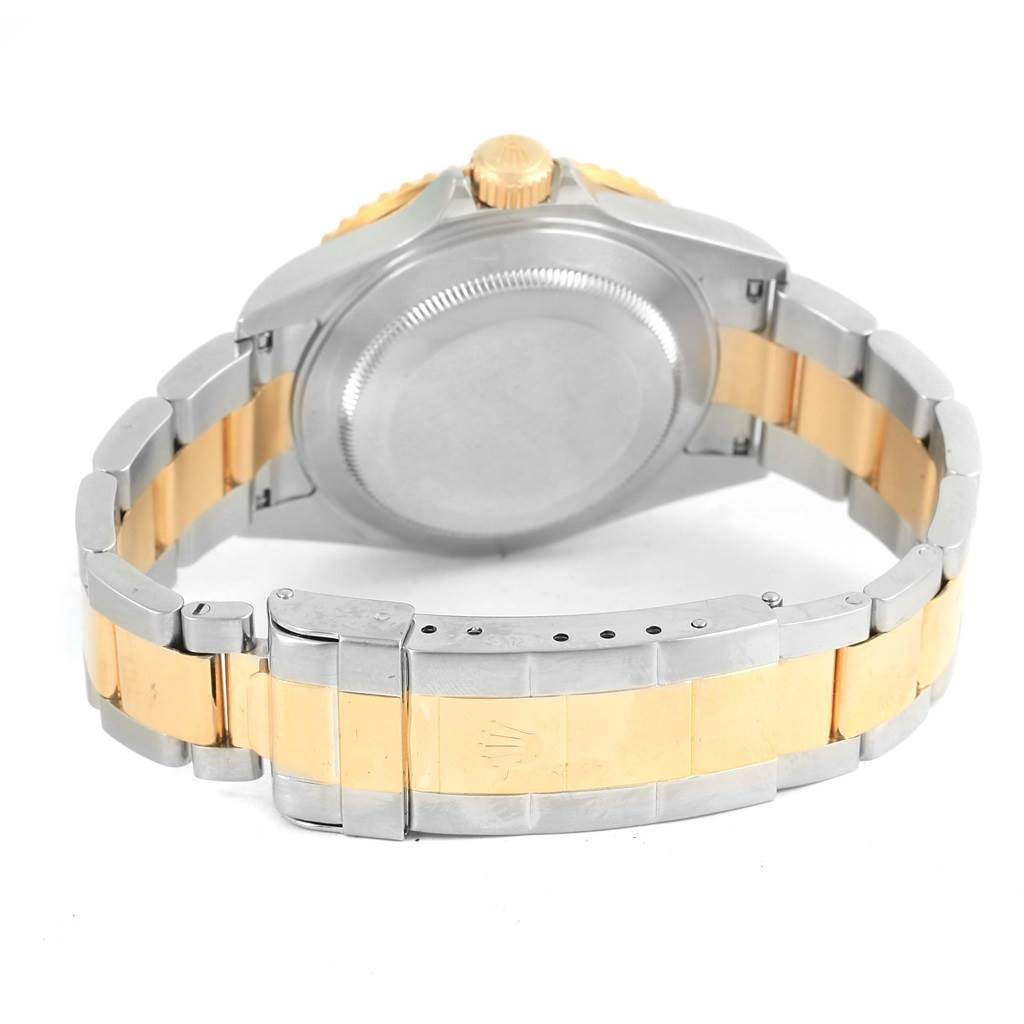 The image shows the back view of a Rolex Submariner 16613 Men's Steel and Gold (two tone) Blue Dial 16613 Men's Steel and Gold (two tone) Blue Dial watch, focusing on its case back, crown, and two-tone bracelet clasp.