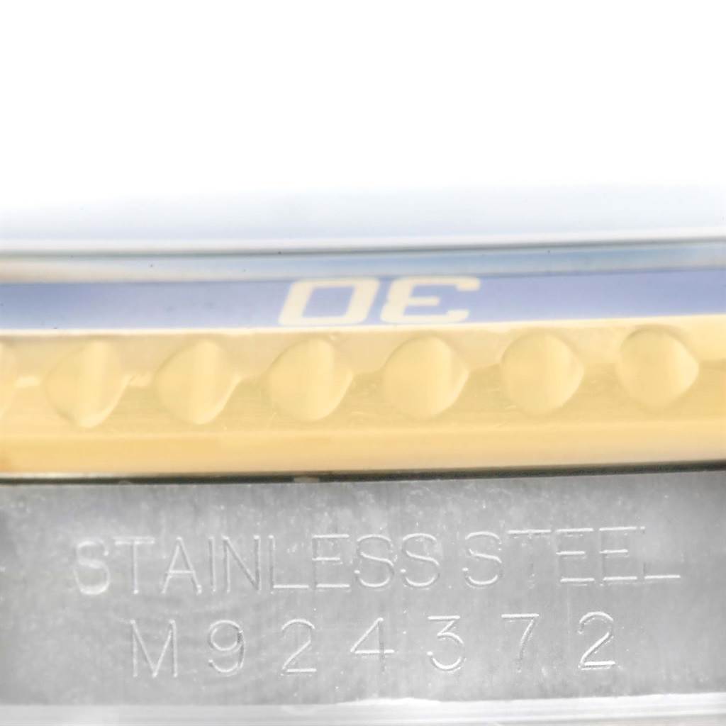 This image shows a close-up of the model number and part of the bezel of a Rolex Submariner 16613 Men's Steel and Gold (two tone) Blue Dial 16613 Men's Steel and Gold (two tone) Blue Dial watch in stainless steel.