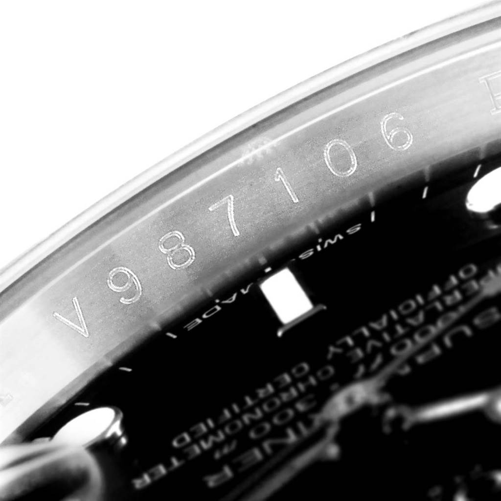 This close-up shows the serial number engraving and part of the dial of the Rolex Submariner 16610 Men's Stainless Steel Black Dial 16610 Men's Stainless Steel Black Dial model.