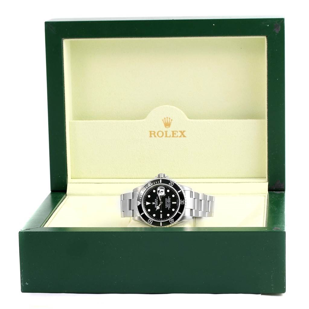 The Rolex Submariner 16610 Men's Stainless Steel Black Dial 16610 Men's Stainless Steel Black Dial watch is displayed front-facing inside its green box with the lid open.