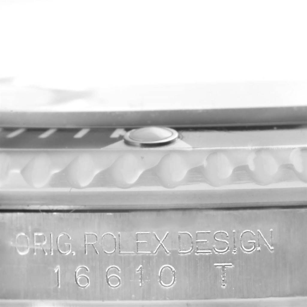 This close-up image shows the bezel edge and engraved case side of a Rolex Submariner 16610 Men's Stainless Steel Black Dial 16610 Men's Stainless Steel Black Dial model 16610.