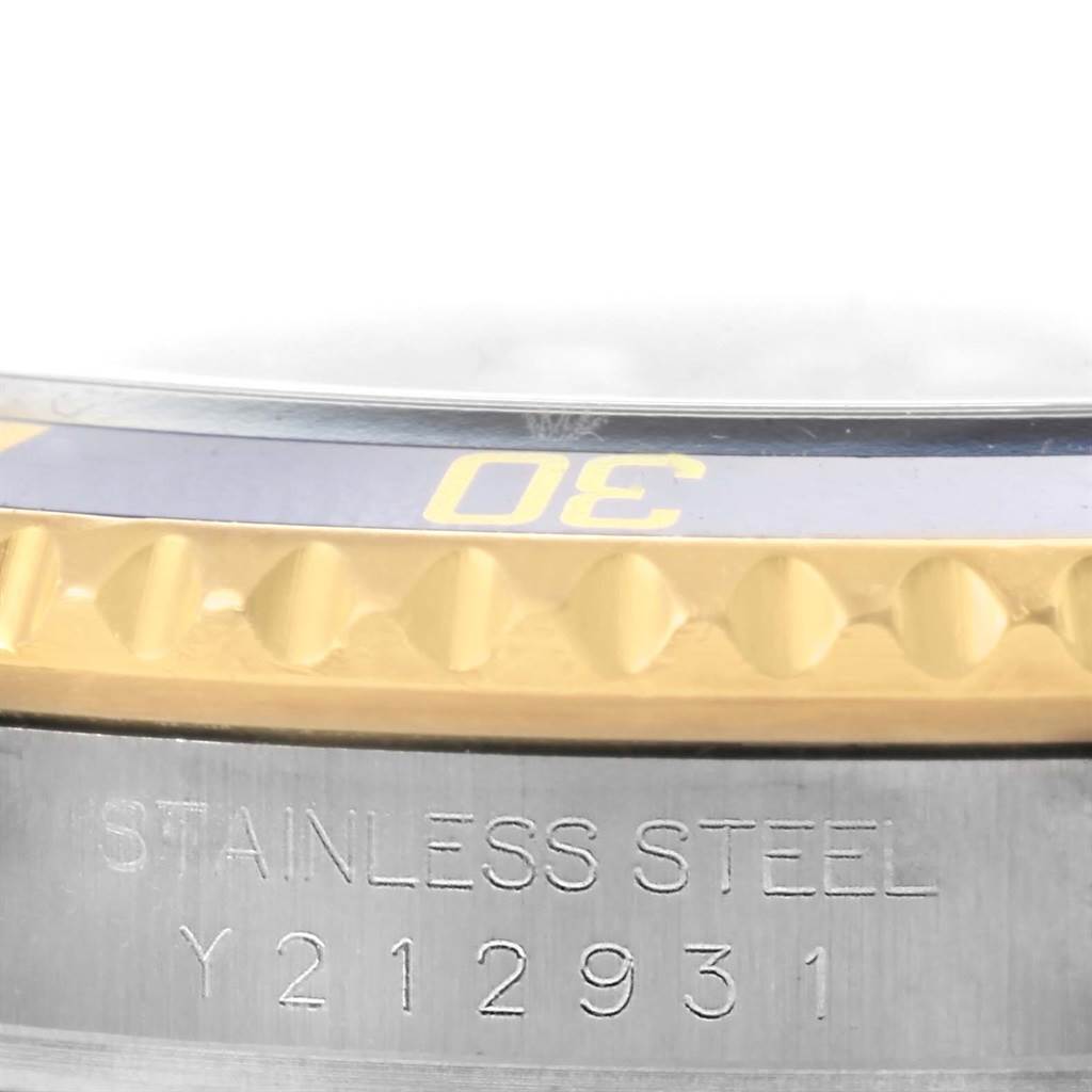 This is a close-up of the bezel and case side of a Rolex Submariner 16613 Men's Steel and Gold (two tone) Blue Dial 16613 Men's Steel and Gold (two tone) Blue Dial, showing part of the 30-minute marker and the "STAINLESS STEEL" engraving.