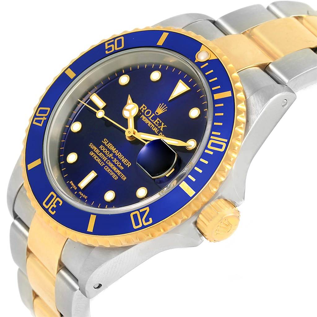 This image shows a close-up of a Rolex Submariner 16613 Men's Steel and Gold (two tone) Blue Dial 16613 Men's Steel and Gold (two tone) Blue Dial watch displaying its blue dial, bezel, and two-tone stainless steel and gold bracelet.