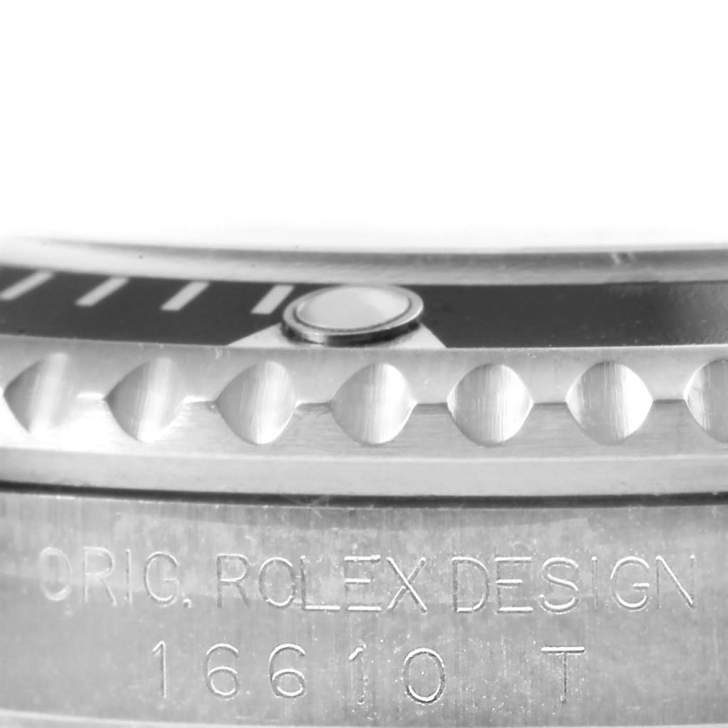 This image shows a close-up of the bezel and side of the case of a Rolex Submariner 16610 Men's Stainless Steel Black Dial 16610 Men's Stainless Steel Black Dial watch, highlighting the engravings.