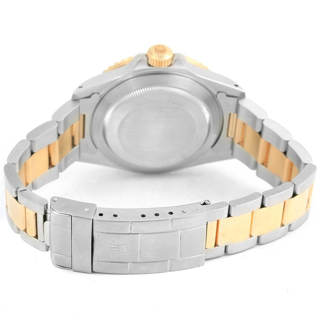 This is a rear view of the Rolex Submariner 16803 Men's Steel and Gold (two tone) Blue Dial 16803 Men's Steel and Gold (two tone) Blue Dial, showing the case back, crown, and bracelet with a clasp.