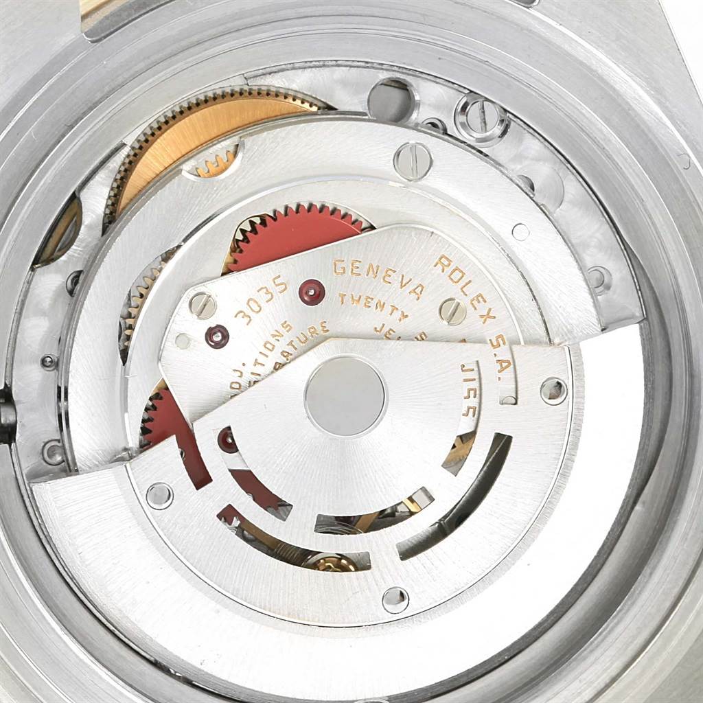 The image shows a close-up of the movement mechanism of a Rolex Submariner 16803 Men's Steel and Gold (two tone) Blue Dial 16803 Men's Steel and Gold (two tone) Blue Dial watch.