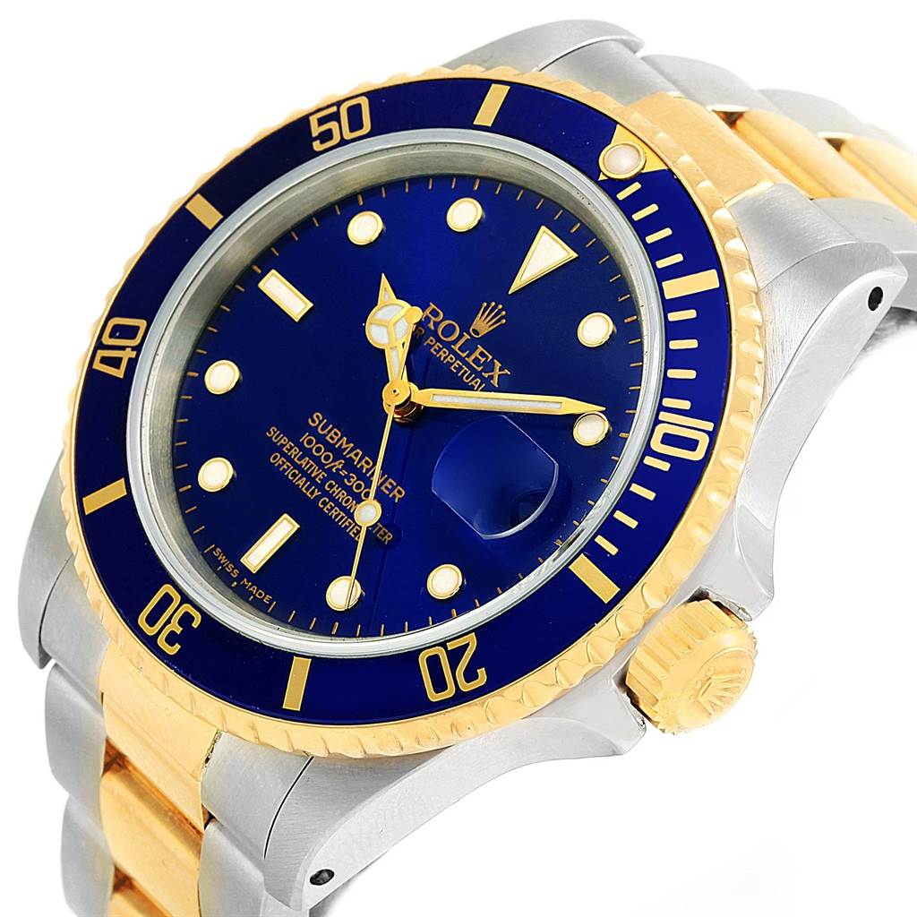 This image shows a close-up, angled view of a Rolex Submariner 16803 Men's Steel and Gold (two tone) Blue Dial 16803 Men's Steel and Gold (two tone) Blue Dial watch featuring the dial, bezel, crown, and part of the bracelet.