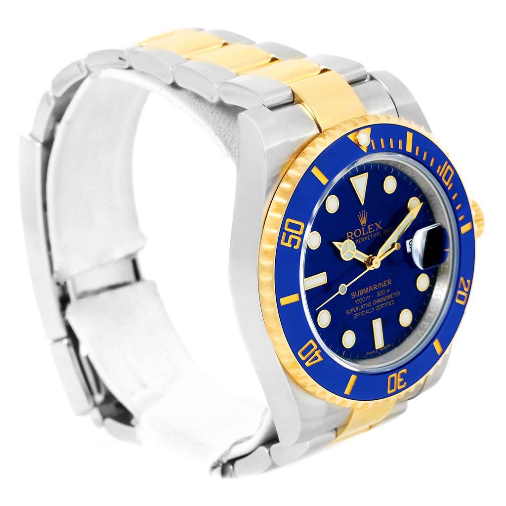 The image shows a Rolex Submariner 116613 Men's Steel and Gold (two tone) Blue Dial 116613 Men's Steel and Gold (two tone) Blue Dial watch at an angle displaying its blue dial, blue and gold bezel, and two-tone bracelet.