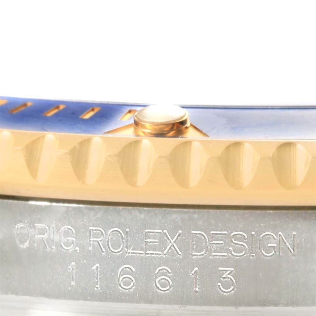 This close-up image shows the side of a Rolex Submariner 116613 Men's Steel and Gold (two tone) Blue Dial 116613 Men's Steel and Gold (two tone) Blue Dial model, highlighting the bezel and model number engraving.