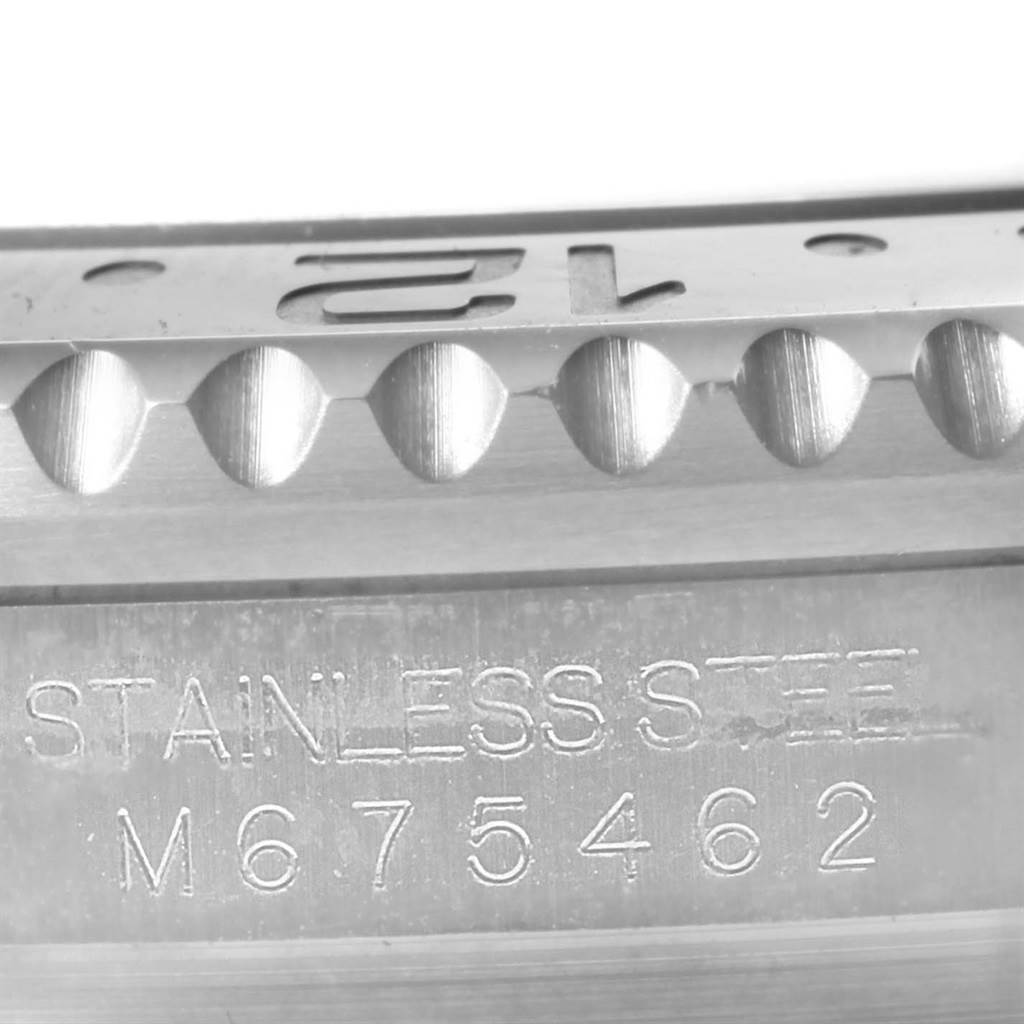 This close-up image shows the engraved bezel and serial number of a Rolex Submariner 116710 Men's Stainless Steel Black Dial 116710 Men's Stainless Steel Black Dial watch.