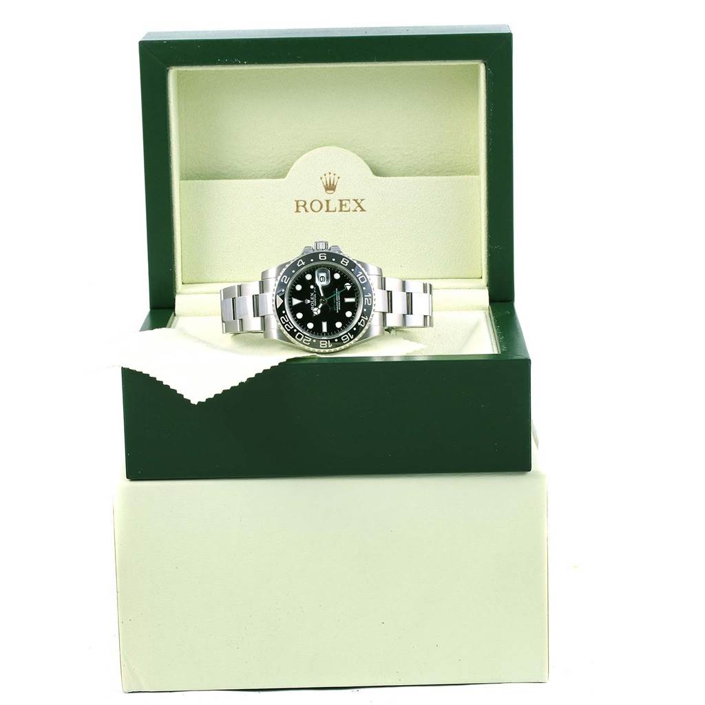 The Rolex Submariner 116710 Men's Stainless Steel Black Dial 116710 Men's Stainless Steel Black Dial watch is displayed frontally in an open green and cream-colored box.