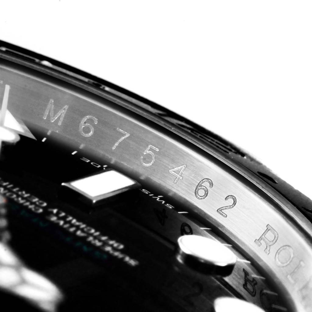 Close-up angle shows part of the Rolex Submariner 116710 Men's Stainless Steel Black Dial 116710 Men's Stainless Steel Black Dial dial with marked serial numbers and part of the bezel.