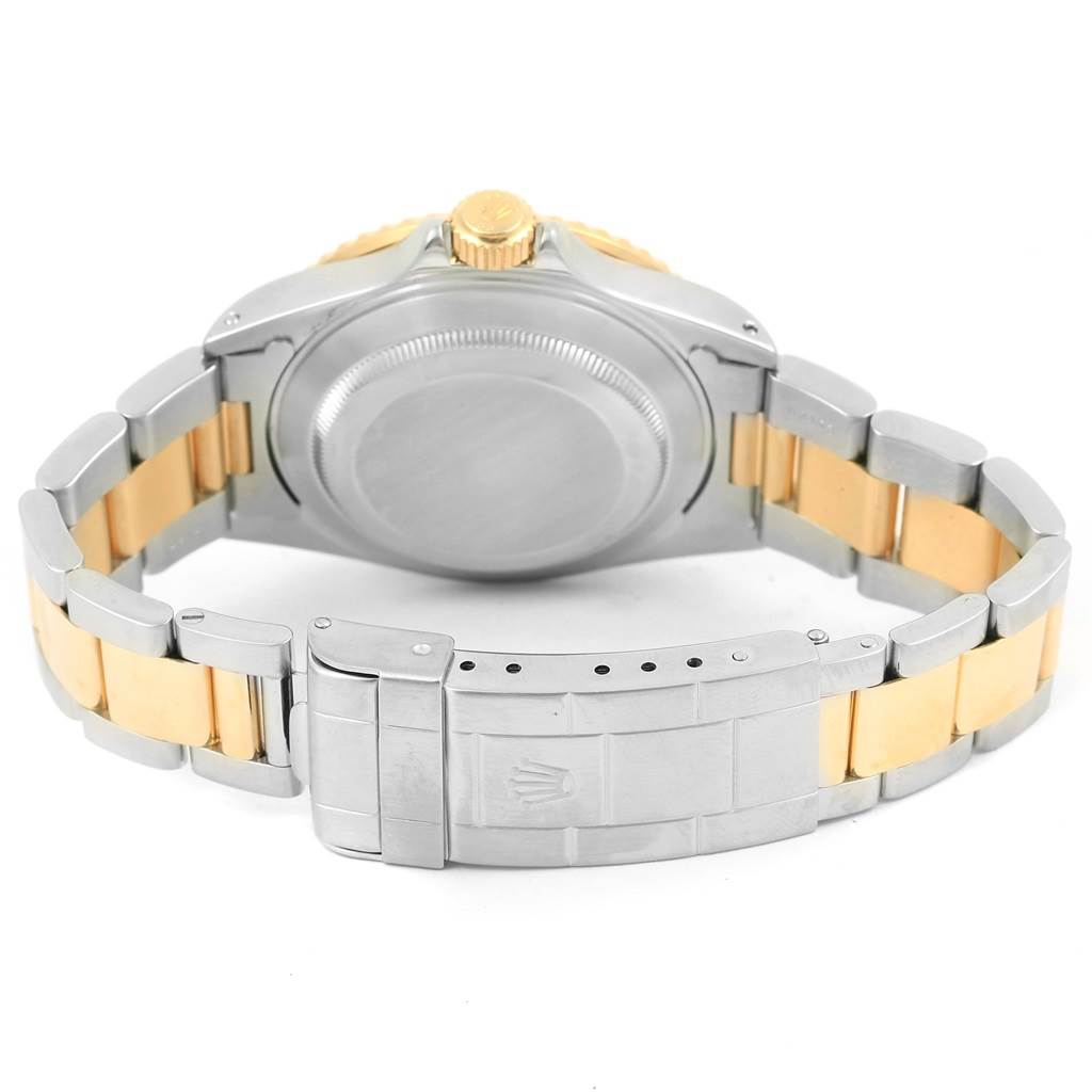 This image shows the back case and bracelet of a Rolex Submariner 16613 Men
s Steel and Gold (two tone) Black Dial 16613 Men
s Steel and Gold (two tone) Black Dial watch, highlighting the two-tone metal design and the clasp.