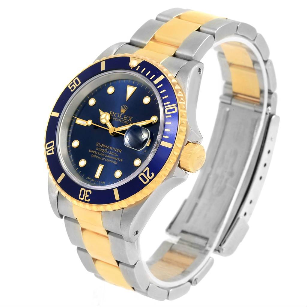 The image shows a Rolex Submariner 16613 Men's Steel and Gold (two tone) Blue Dial 16613 Men's Steel and Gold (two tone) Blue Dial from a side angle, highlighting its blue and gold bezel, crown, and two-tone bracelet.