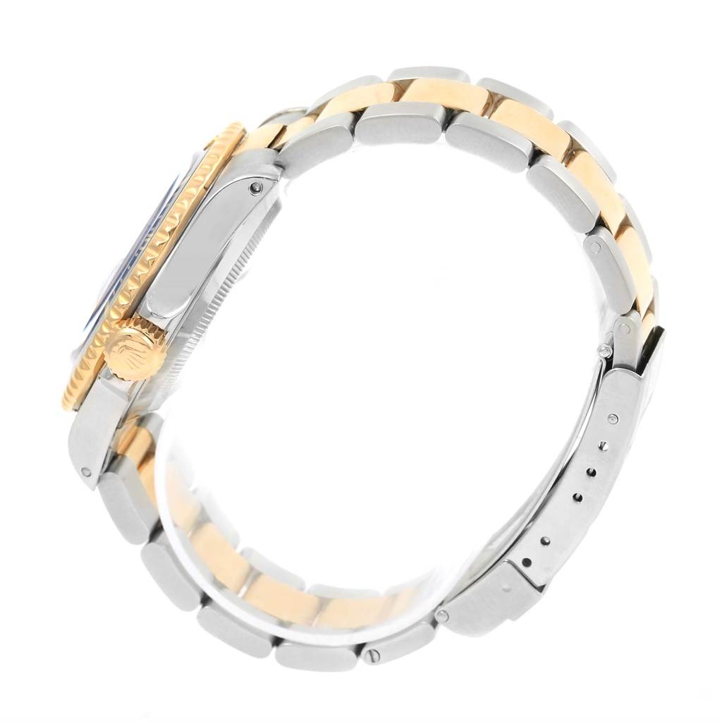 The image shows a side view of a Rolex Submariner 16613 Men's Steel and Gold (two tone) Blue Dial 16613 Men's Steel and Gold (two tone) Blue Dial watch, displaying the two-tone bracelet, crown, and part of the bezel.