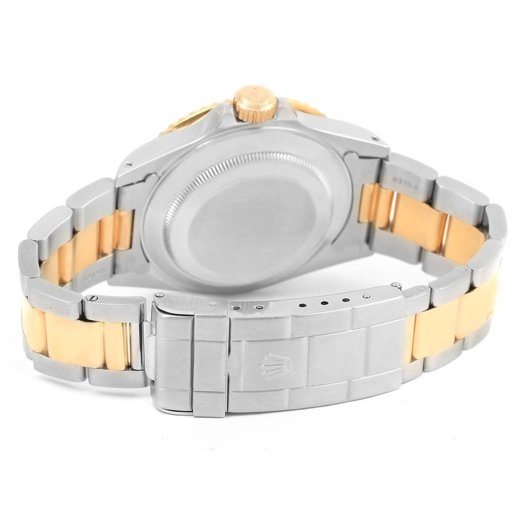 The image shows the back case and bracelet of a Rolex Submariner 16613 Men's Steel and Gold (two tone) Blue Dial 16613 Men's Steel and Gold (two tone) Blue Dial, focusing on the deployment clasp and crown.