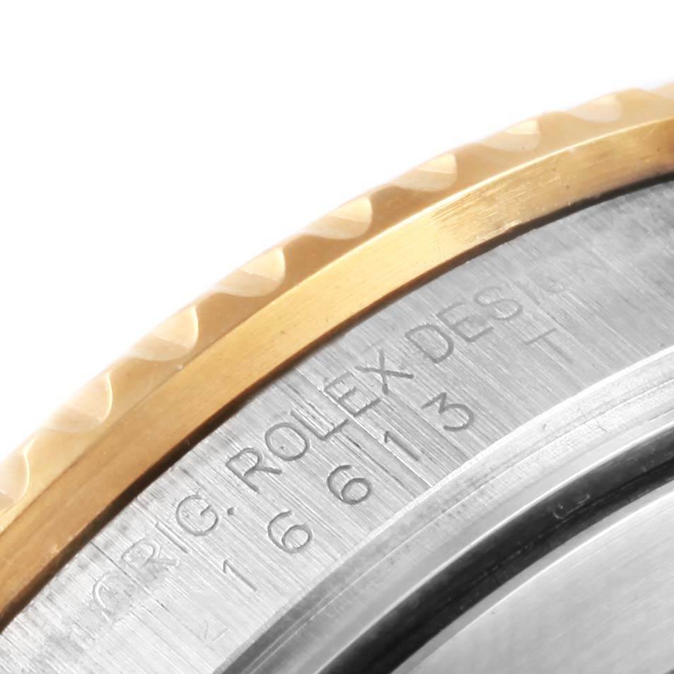 This image shows a close-up of the engraved side of the bezel and case on a Rolex Submariner 16613 Steel and Gold (two tone) Blue Dial 16613 Steel and Gold (two tone) Blue Dial watch.