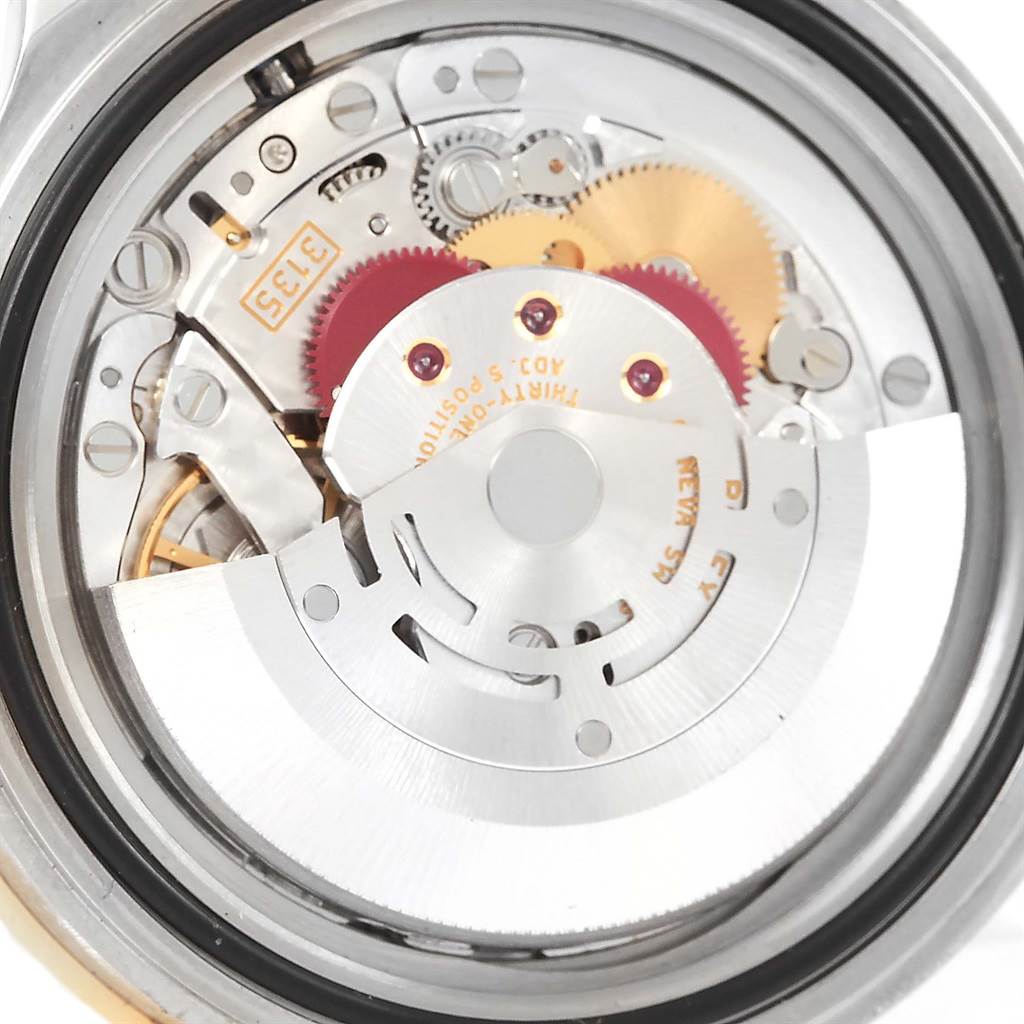 This is a close-up view of the movement components inside a Rolex Submariner 16613 Steel and Gold (two tone) Blue Dial 16613 Steel and Gold (two tone) Blue Dial watch, showing gears and the oscillating weight.