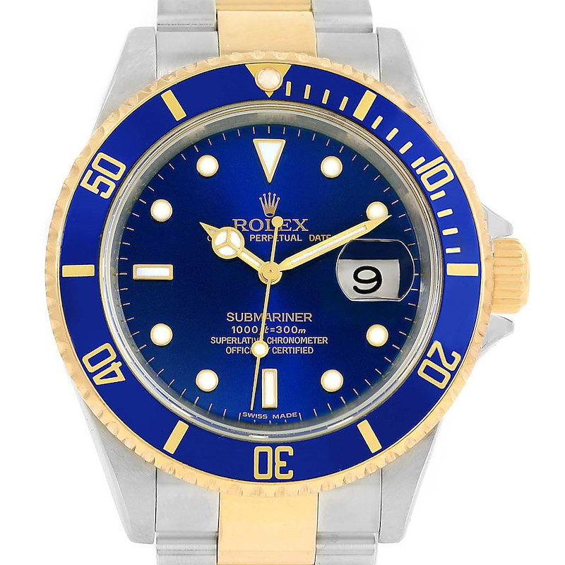 The image shows a front view of a Rolex Submariner with a blue dial, date window, and a gold and silver bracelet.