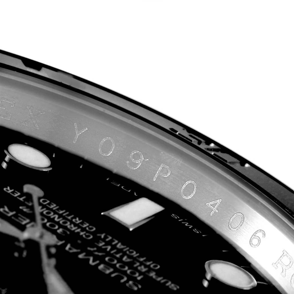 This close-up image shows the Rolex Submariner 114060 Men's Stainless Steel Black Dial 114060 Men's Stainless Steel Black Dial's serial number and part of the dial.