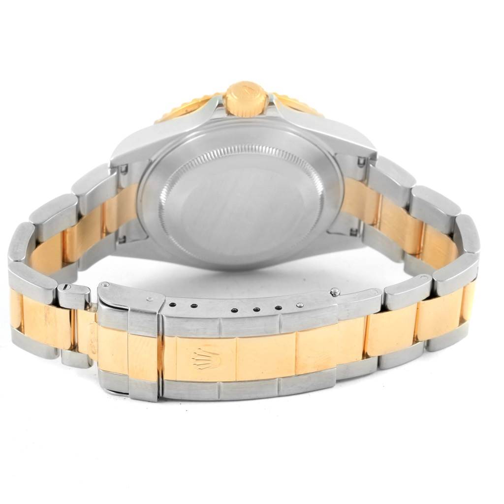 This image shows the back view of a Rolex Submariner 16613 Men
s Steel and Gold (two tone) Black Dial 16613 Men
s Steel and Gold (two tone) Black Dial watch and its two-tone bracelet with the clasp open.