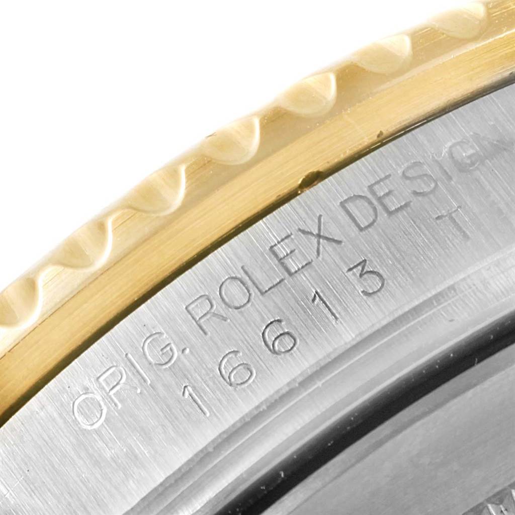 This close-up image of the Rolex Submariner 16613 Men's Steel and Gold (two tone) Blue Dial 16613 Men's Steel and Gold (two tone) Blue Dial shows the engraved side with the model number 16613 and part of the bezel.