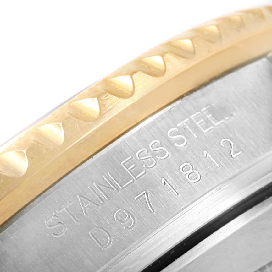 This image shows a close-up of the bezel and case back with engraving on a Rolex Submariner 16613 Men's Steel and Gold (two tone) Blue Dial 16613 Men's Steel and Gold (two tone) Blue Dial watch.