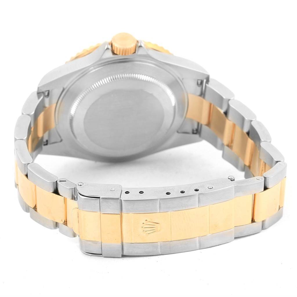 The image shows the back view of a Rolex Submariner 16613 Men's Steel and Gold (two tone) Blue Dial 16613 Men's Steel and Gold (two tone) Blue Dial watch with its case back and two-tone metal bracelet.