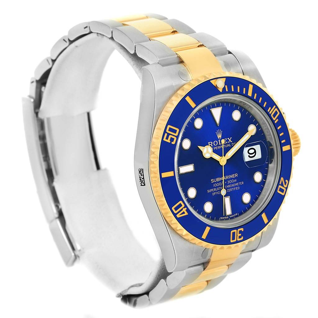 The image shows a side-angle view of a Rolex Submariner 116613 Men's Steel and Gold (two tone) Blue Dial 116613 Men's Steel and Gold (two tone) Blue Dial watch, highlighting the blue dial, bezel, and gold and silver bracelet.