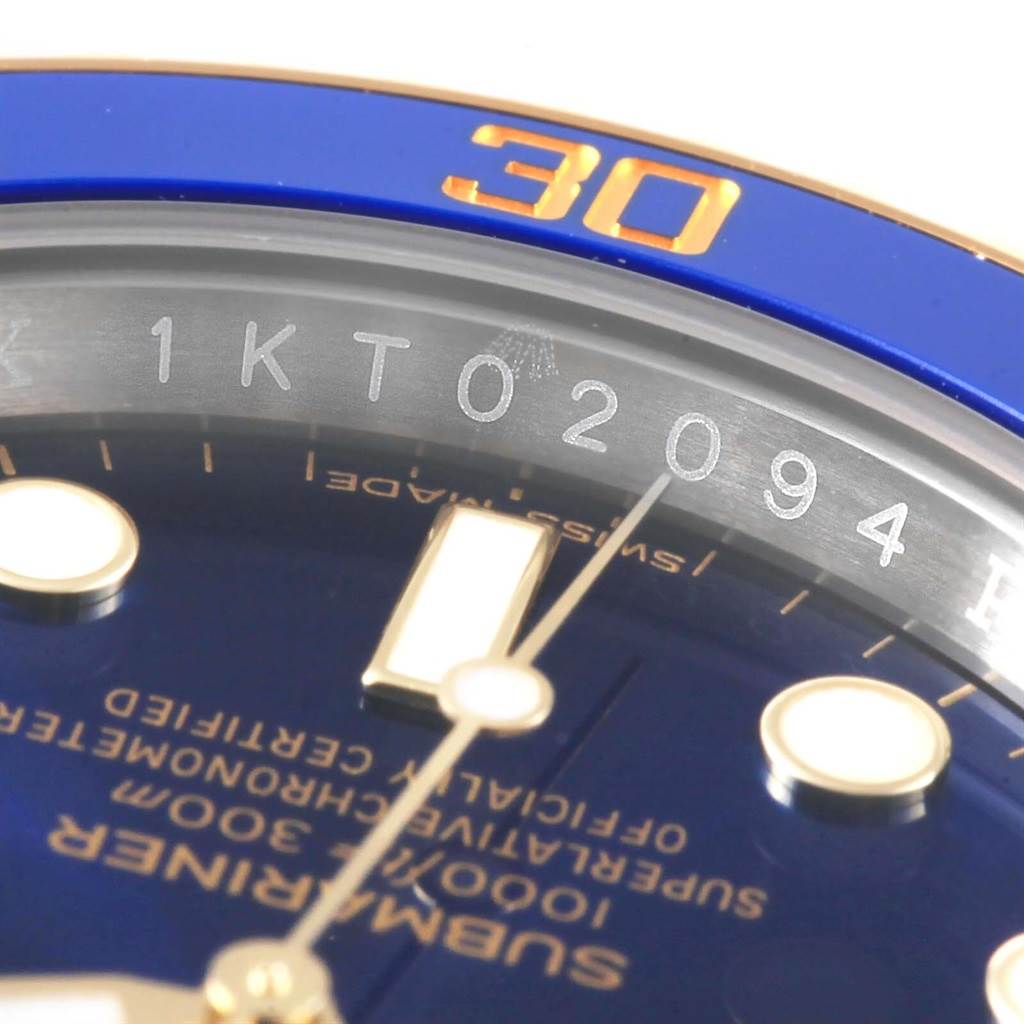 This image shows a close-up of a Rolex Submariner 116613 Men's Steel and Gold (two tone) Blue Dial 116613 Men's Steel and Gold (two tone) Blue Dial watch face, emphasizing the bezel, serial number, and dial details.