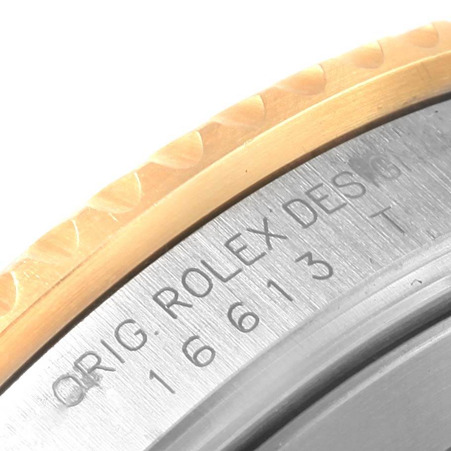 This close-up image shows the engraved model number and bezel edge of a Rolex Submariner 16613 Men
s Steel and Gold (two tone) Grey Dial 16613 Men
s Steel and Gold (two tone) Grey Dial watch.