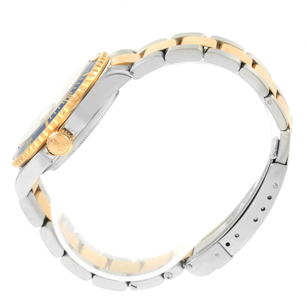 The Rolex Submariner 16613 Men
s Steel and Gold (two tone) Grey Dial 16613 Men
s Steel and Gold (two tone) Grey Dial model is shown from a side angle, highlighting the bezel, crown, and two-tone bracelet.