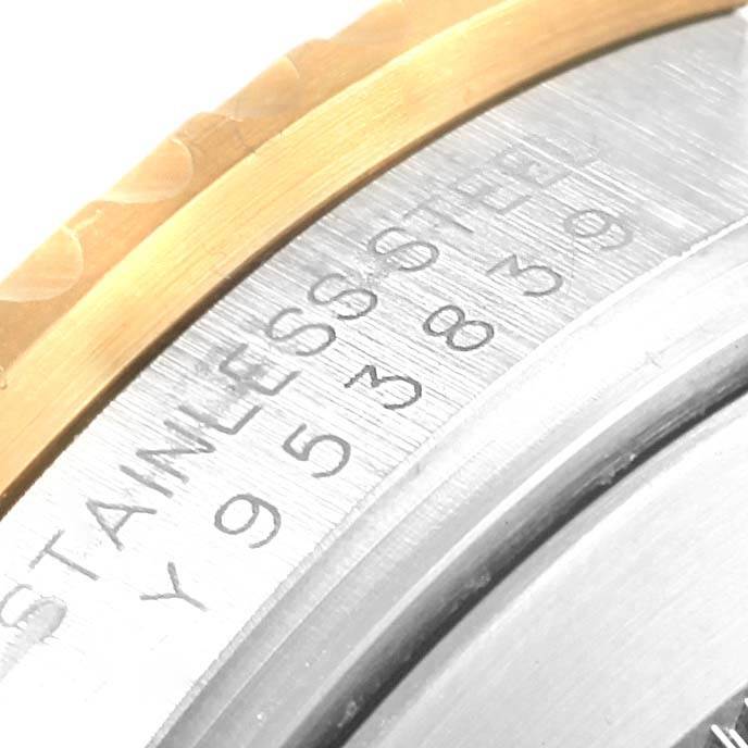 This close-up image shows the engraved stainless steel case back and part of the bezel of a Rolex Submariner 16613 Men
s Steel and Gold (two tone) Grey Dial 16613 Men
s Steel and Gold (two tone) Grey Dial watch.