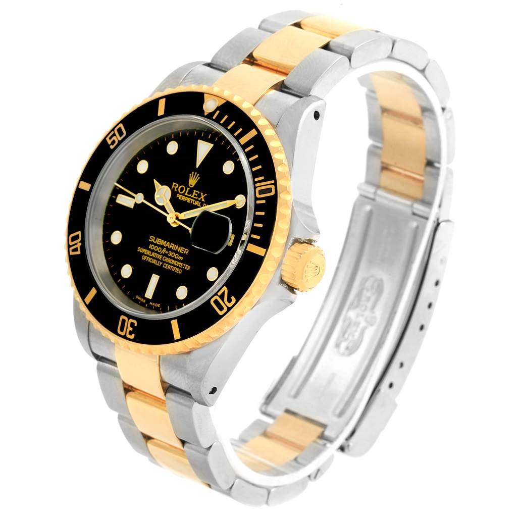 The image shows a Rolex Submariner 16613 Men's Steel and Gold (two tone) Black Dial 16613 Men's Steel and Gold (two tone) Black Dial watch at a three-quarter angle, highlighting its face, bezel, and two-tone bracelet.