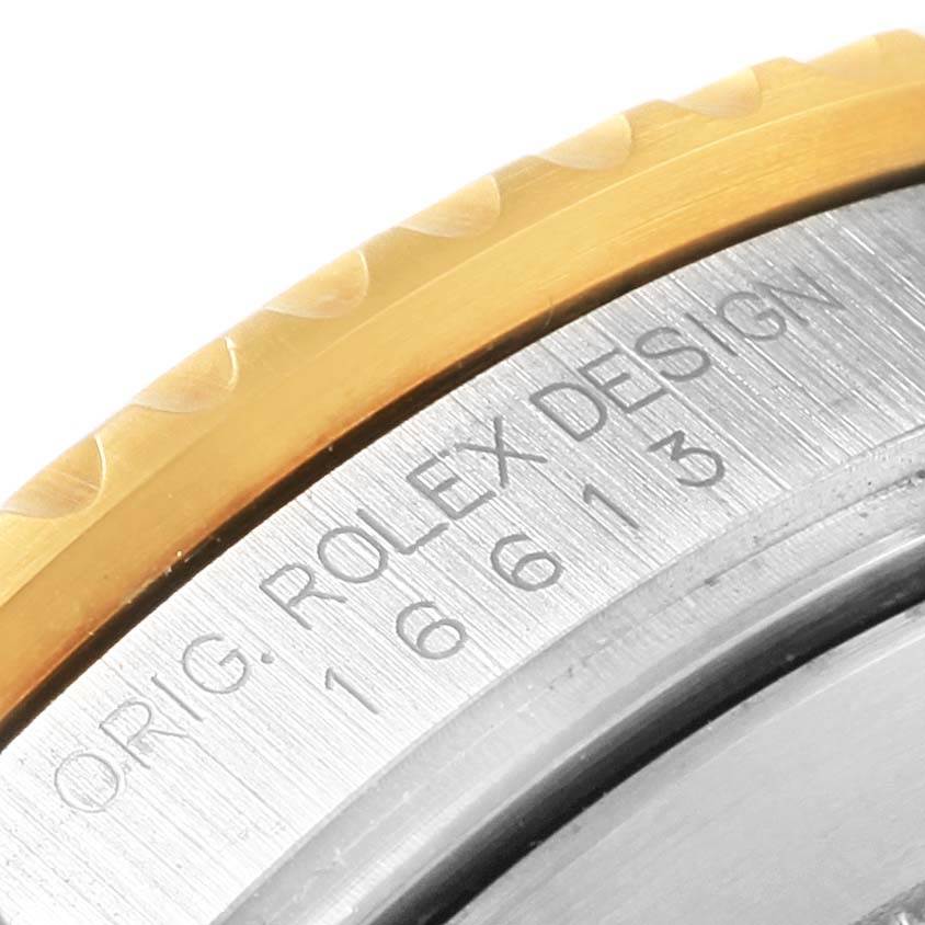 This image shows a close-up of the bezel and case number engraving of a Rolex Submariner 16613 Men's Steel and Gold (two tone) Black Dial 16613 Men's Steel and Gold (two tone) Black Dial watch.