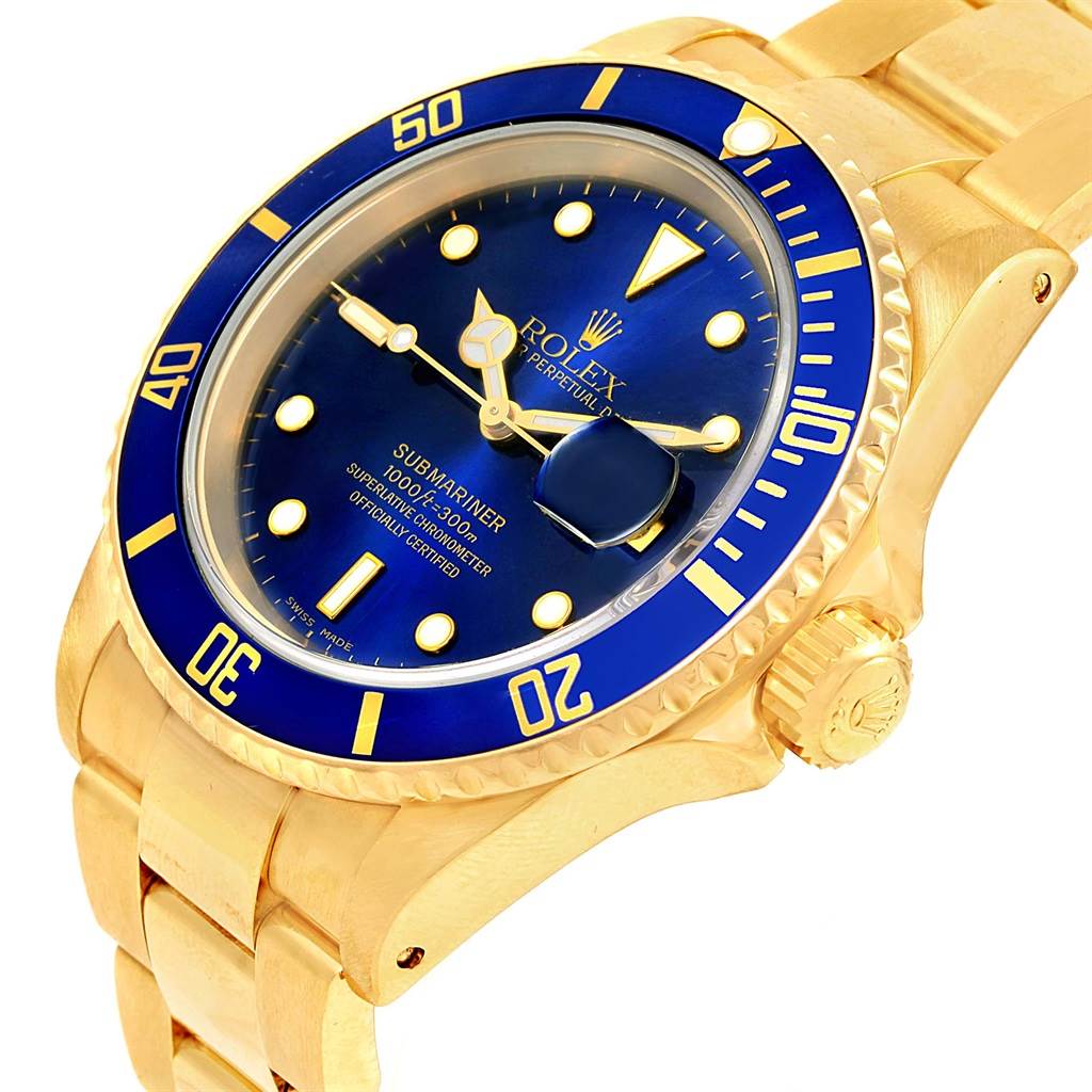 The image shows an angled view of a Rolex Submariner 16618 Men's Yellow Gold Blue Dial 16618 Men's Yellow Gold Blue Dial watch, highlighting its blue dial, bezel, and gold bracelet.