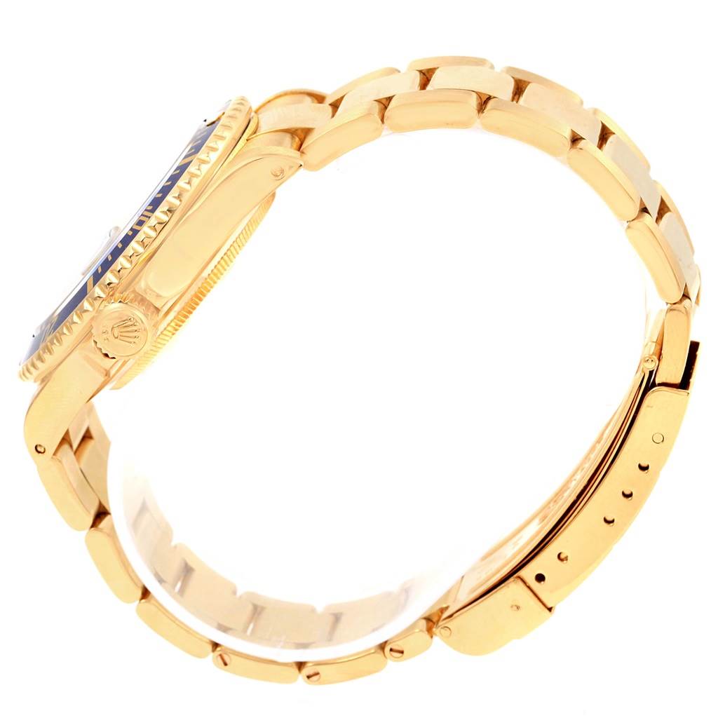 The image shows a side view of a Rolex Submariner 16618 Men's Yellow Gold Blue Dial 16618 Men's Yellow Gold Blue Dial watch, focusing on its gold case and bracelet.