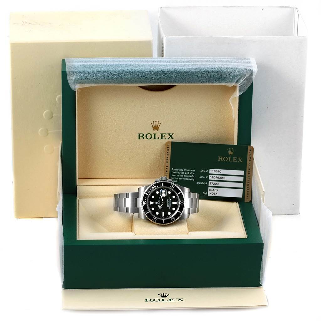 The Rolex Submariner 116610 Men's Stainless Steel Black Dial 116610 Men's Stainless Steel Black Dial watch is displayed in an open green and beige box with a certification card beside it.
