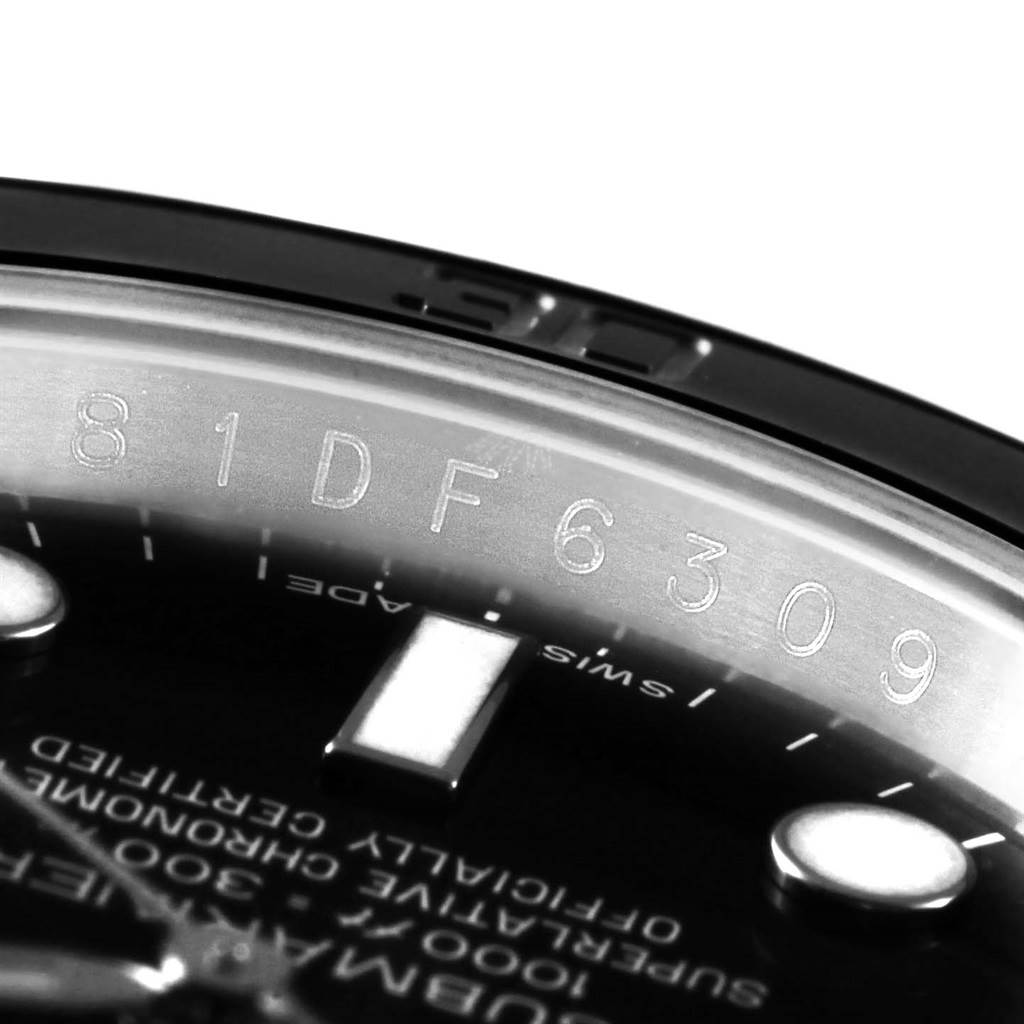 This close-up shows the serial number engraving on the inner bezel of a Rolex Submariner 116610 Men's Stainless Steel Black Dial 116610 Men's Stainless Steel Black Dial watch.