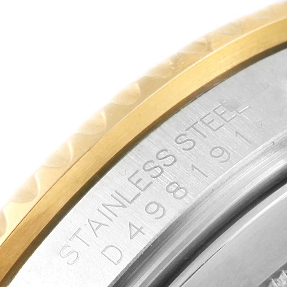 This image shows a close-up angle of the side of a Rolex Submariner 16613 Men's Steel and Gold (two tone) Blue Dial 16613 Men's Steel and Gold (two tone) Blue Dial watch, highlighting part of the stainless steel casing and the serial number.