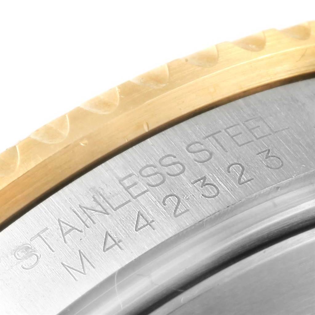 The image shows a close-up of the side and back casing with engravings on a Rolex Submariner 16613 Men
s Steel and Gold (two tone) Black Dial 16613 Men
s Steel and Gold (two tone) Black Dial watch.