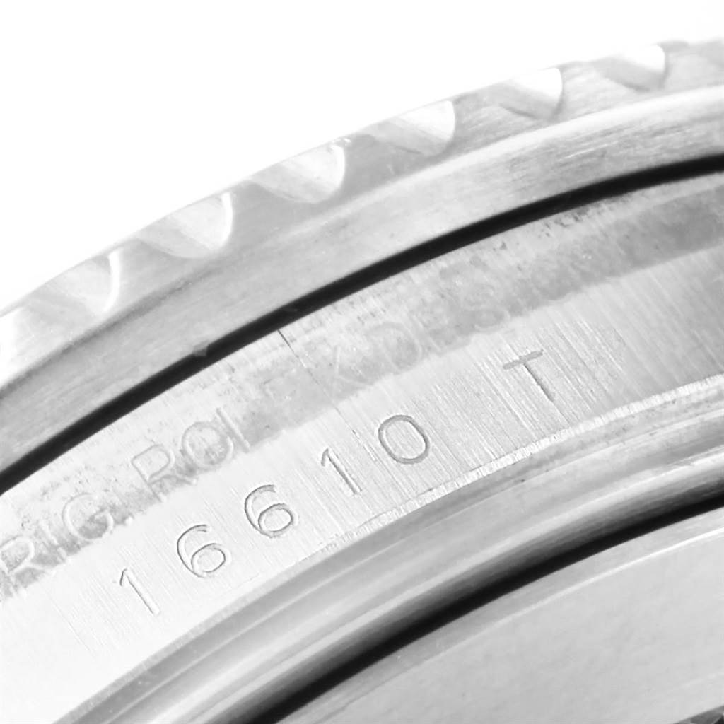 The image shows a close-up of the bezel and serial number engraving on the case of a Rolex Submariner 16610 Men's Stainless Steel Black Dial 16610 Men's Stainless Steel Black Dial.