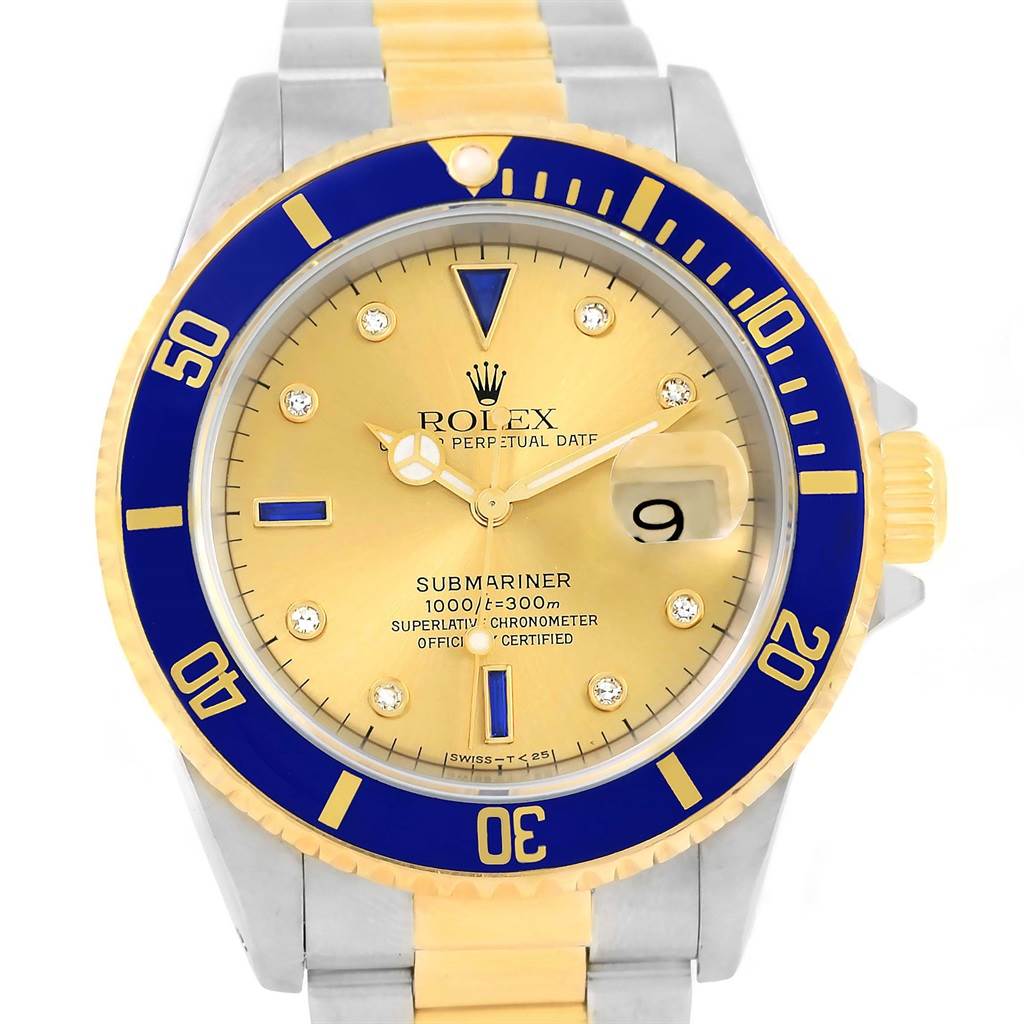 The Rolex Submariner 16613 Men
s Steel and Gold (two tone) Champagne Dial 16613 Men
s Steel and Gold (two tone) Champagne Dial watch is shown from a top-down angle, displaying its dial, bezel, and part of the bracelet.