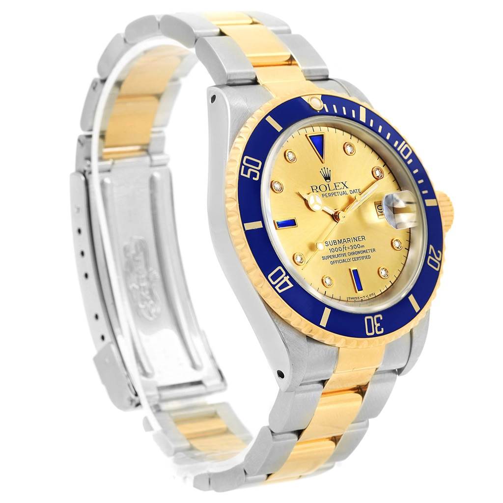 This image shows a side angle of a Rolex Submariner 16613 Men
s Steel and Gold (two tone) Champagne Dial 16613 Men
s Steel and Gold (two tone) Champagne Dial watch, highlighting its gold and blue bezel, dial, and two-tone bracelet.